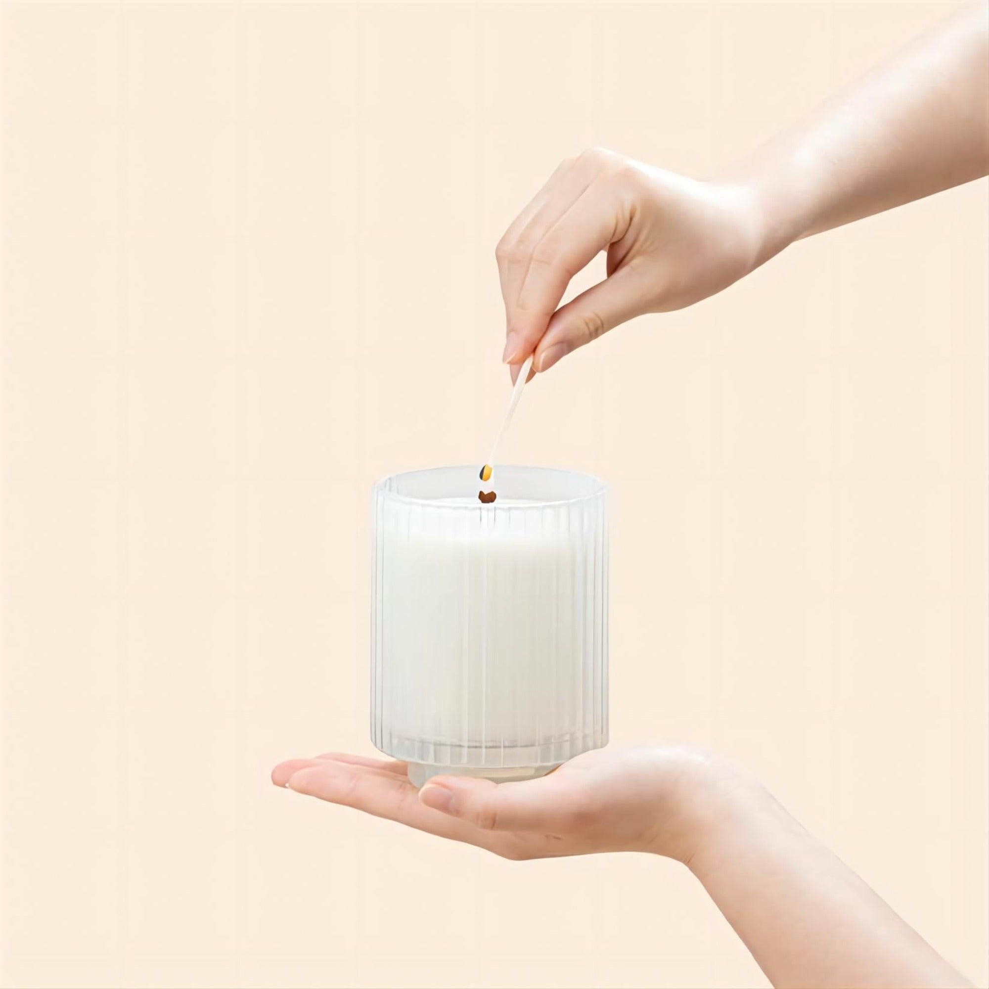 Photo shot of lighting Amélie - Vanilla Coconut 12.3oz candle with a match
