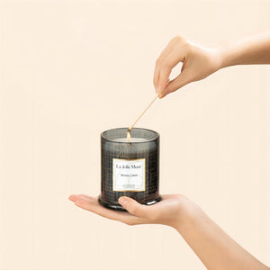 Photo shot of lighting Roesia - Breezy Linen 9.9oz candle with a match