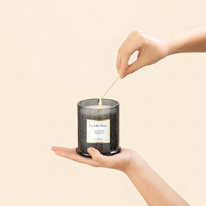 Photo shot of lighting Roesia - Dark Berries & Bergamot 9.9oz candle with a match