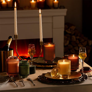 Collection shot of Amélie candles in various scents and sizes with dinner candles lit - view 1