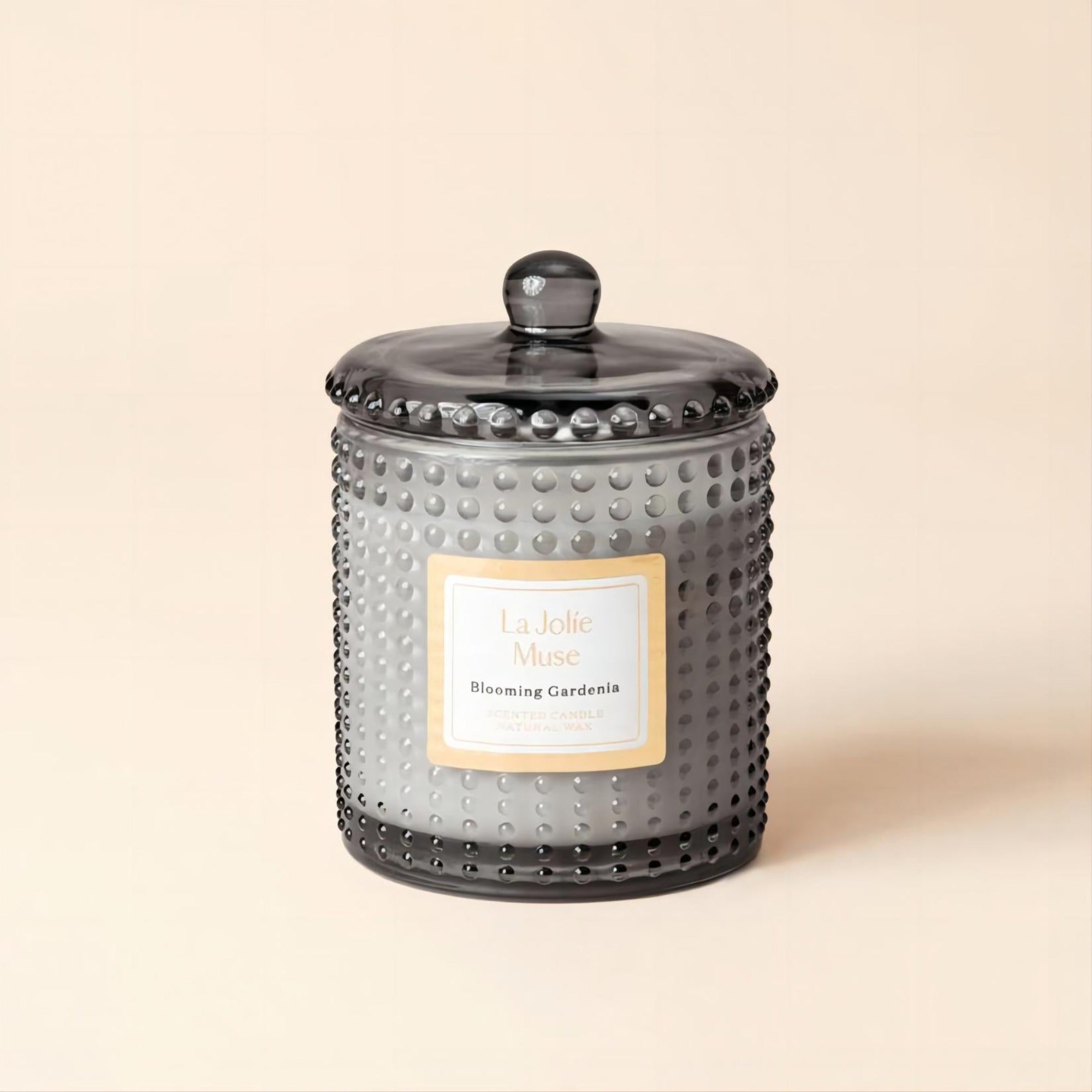 Product Shot of Marvella - Blooming Gardenia 10oz candle in the middle