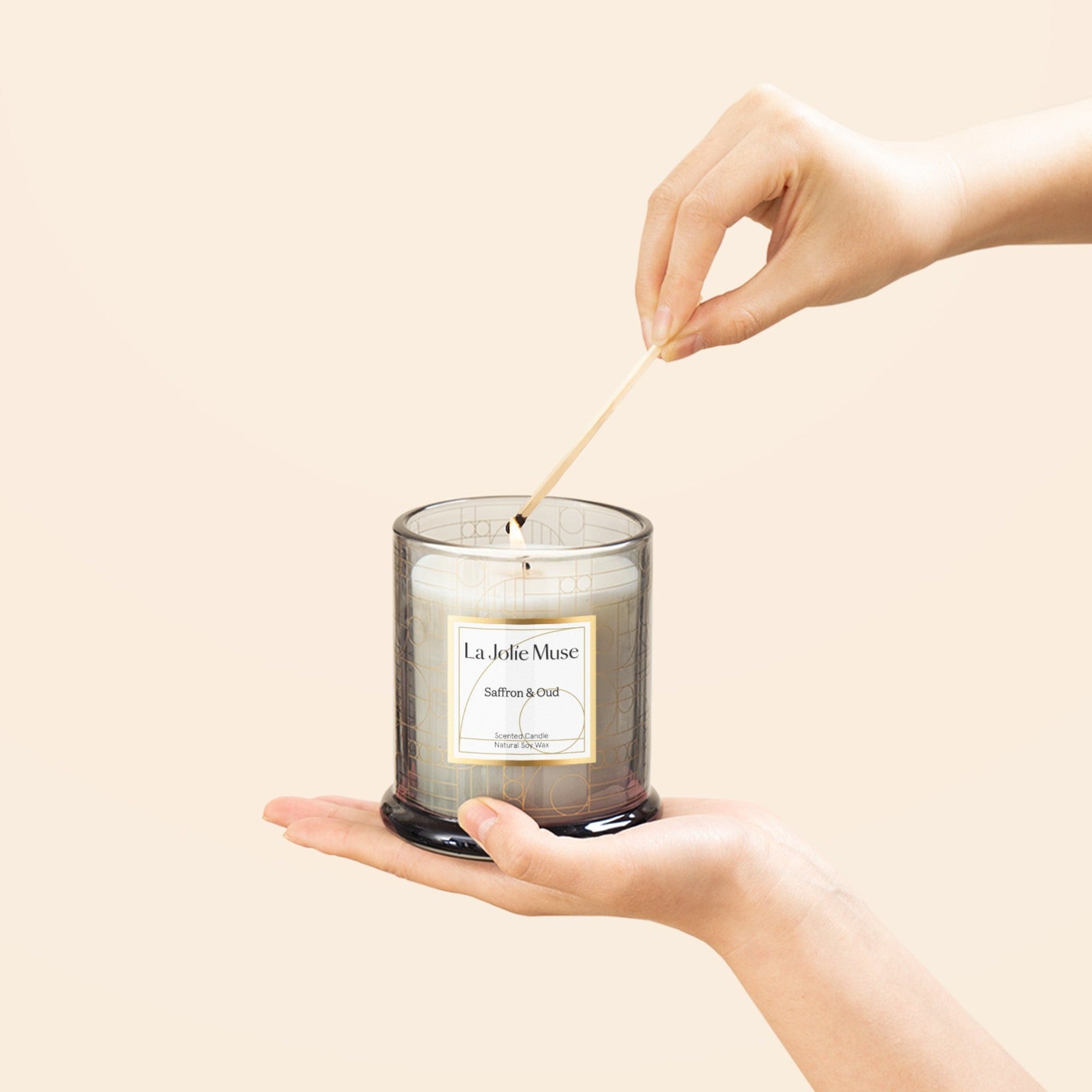 Photo shot of lighting Roesia - Saffron & Oud 10oz candle with a match