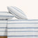 Camille Blue Stripe cotton set. Two blue and white dotted pillows on blue and white dotted duvet from side view. 