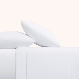 Camille Classic White set. White pillows on white duvet from side view. 