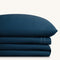 Sofia Navy Blue Double Satin Stitched Cuff 300 thread count cotton bed sheet set. Single navy pillow stacked on folded navy sheet set.