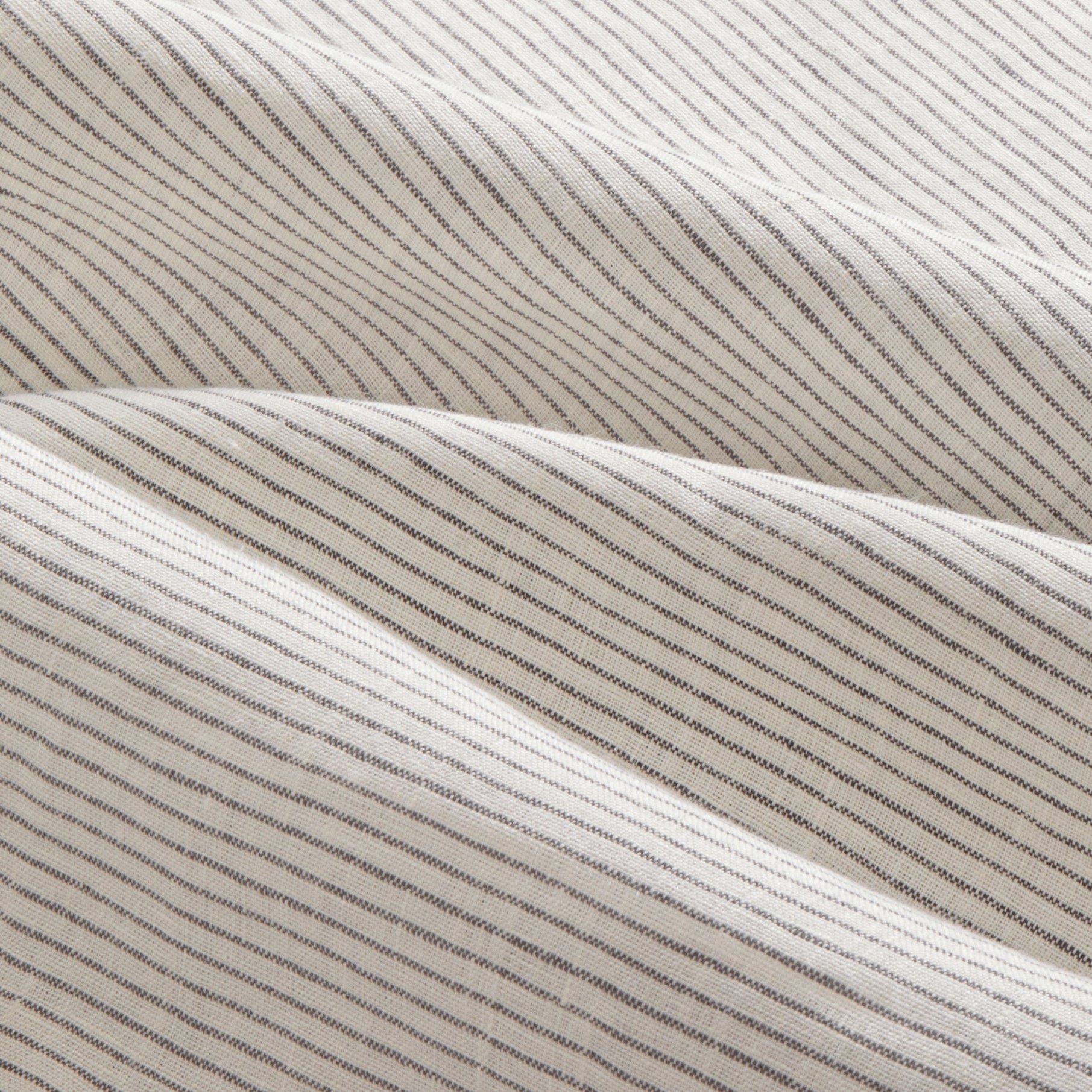 Close up details of Olivia black and white stripe linen sheet set. Black and white striped linen bedsheet set close up.
