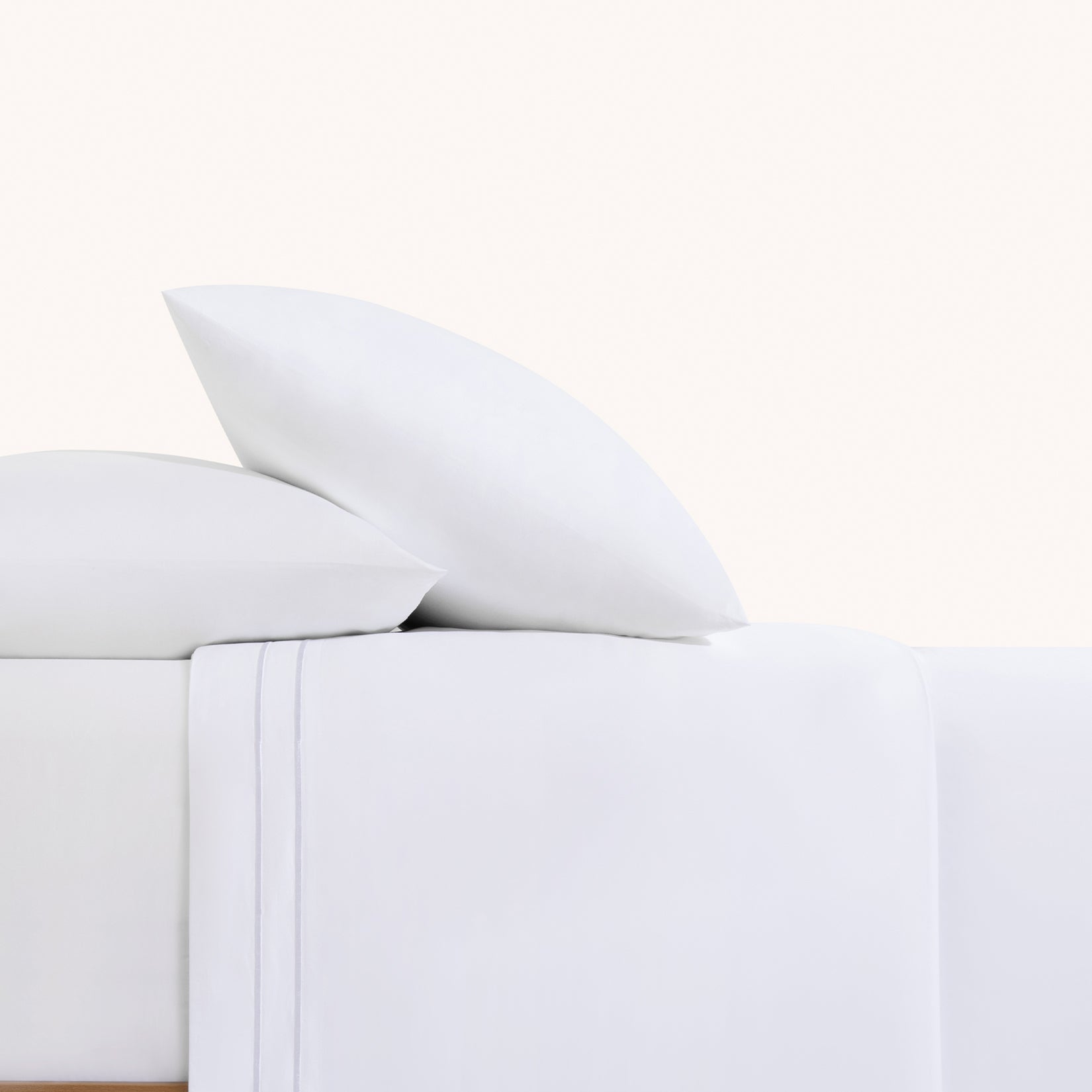Sofia Classic White Double Satin Stitched Cuff 300 thread count cotton bed sheet set. White pillows and white sheets with embroidered hem on bed.