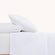 Sofia Classic White Double Satin Stitched Cuff 300 thread count cotton bed sheet set. White pillows and white sheets with embroidered hem on bed.