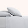 Olivia foggy gray linen sheet set. Foggy gray pillows and foggy gray sheets on bed from side view.