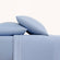 Paulina Sky Blue Satin Stitched Cuff 200 thread count cotton bed sheet set. Sky blue pillows and sky blue sheets with embroidered hem on bed.