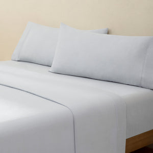 Olivia foggy gray linen bed set. Foggy gray linen pillows and foggy gray linen sheets on bed from side angle.