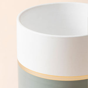 A close-up of the 6.7-inch tall pot, showing the gray painting and golden line design near the bottom.