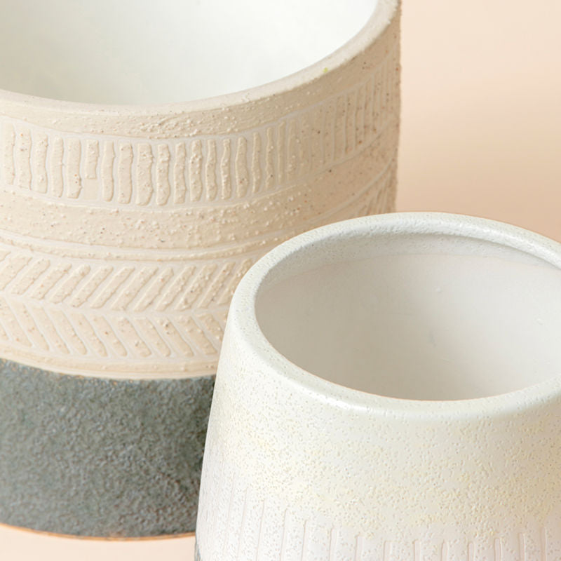 A close-up of the pots set, showing its herringbone and ribbed pattern design around the exterior.