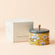 A tin of Orange and Bergamot Scented candle and its white packing box.