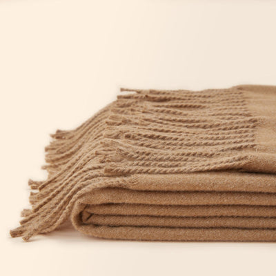 A full view of a folded Angie camel faux fleece fringed throw blanket is displayed.