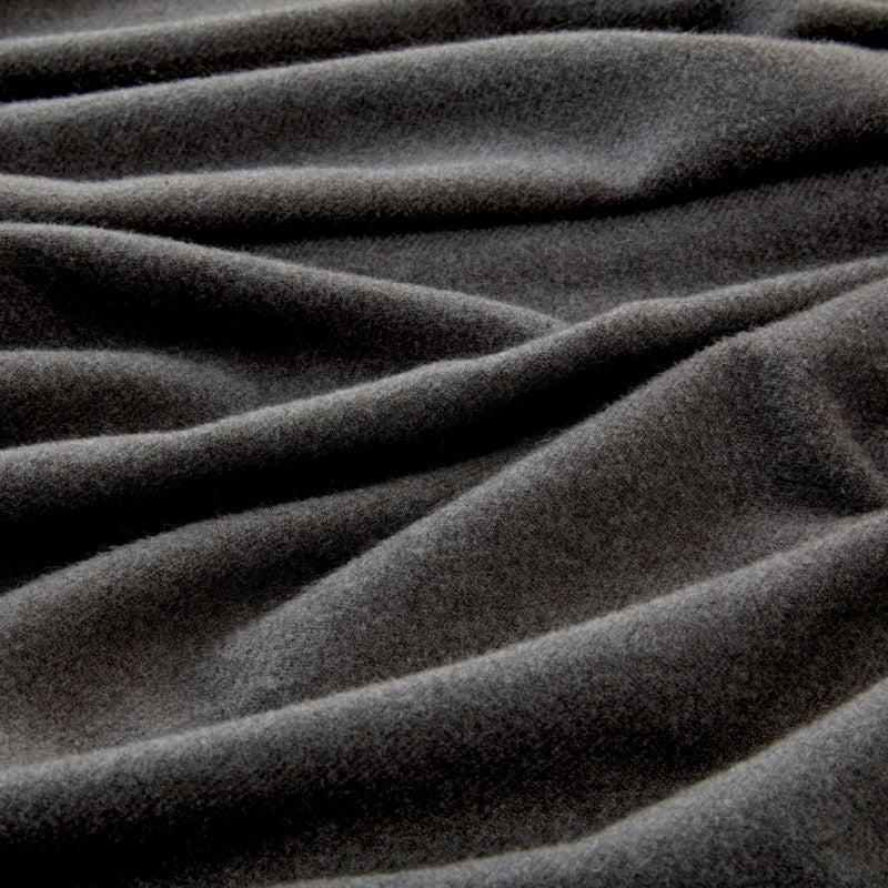 The demonstration of the smoky gray throw fabric, showing its soft feature and skin-friendly touch.