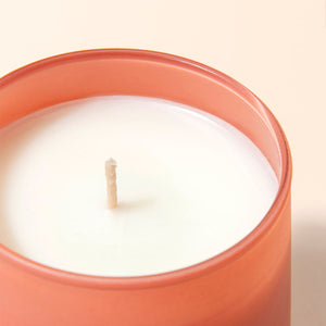 A close up of Apricot Rose candle, showing its cotton wick.