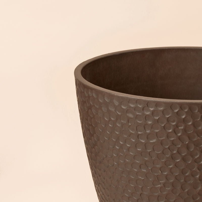 A close-up of the bee brown pot, showing its honeycomb patterns around the exterior and smooth rim.