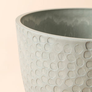 A close up of storm gray pot, showing the textured honeycomb pattern around its exterior.