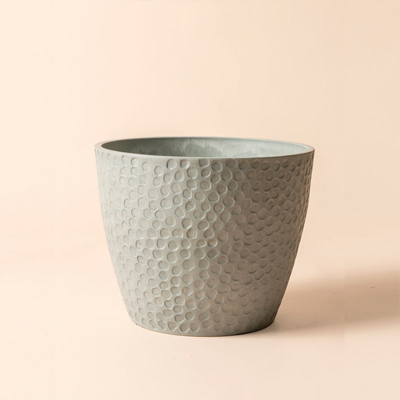A full view of storm gray pot with honeycomb pattern, made from recyclable plastic and natural stone powders.