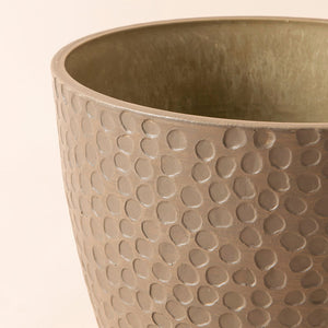 A very close look of a taupe plant, made with recyclable plastic and  designed with a honeycomb pattern.