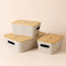 A set of three beige bamboo utility baskets baskets are placed in a staggered way, all with bamboo lids.