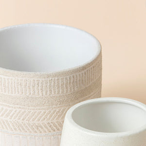 A close-up picture of the patterns on the Allen pots set. The left one is in beige, and the right one is creamy green.