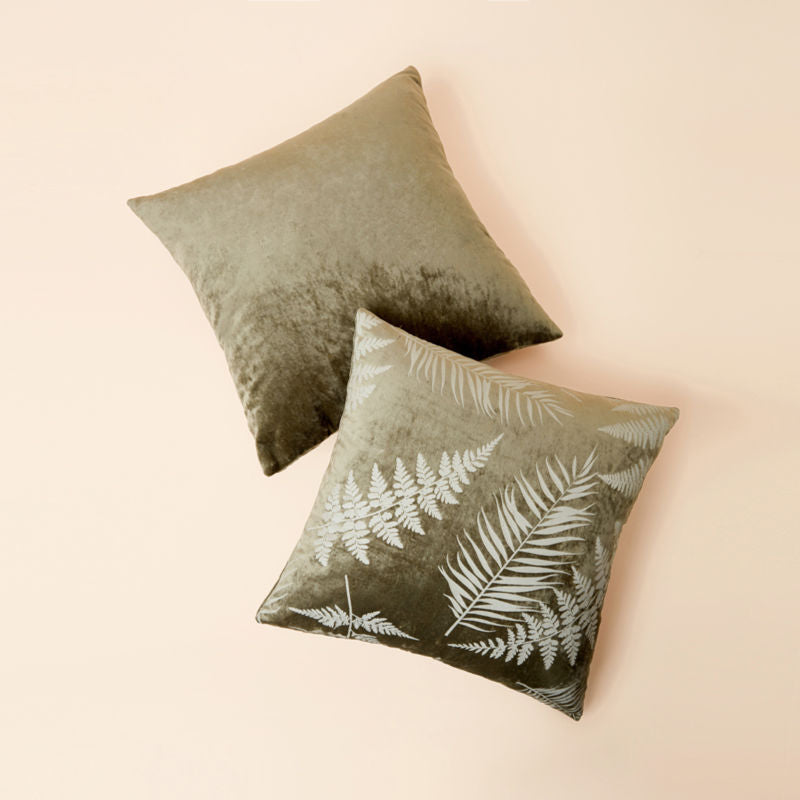 A pair of pillows in 18 * 18 inch Belinda sage green leafy pattern velveteen pillow cover is displayed in a staggered position.