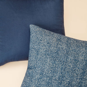 A group of two pillows in Bena navy blue pillow cover is displayed, one showing the front side, the other showing the back side.