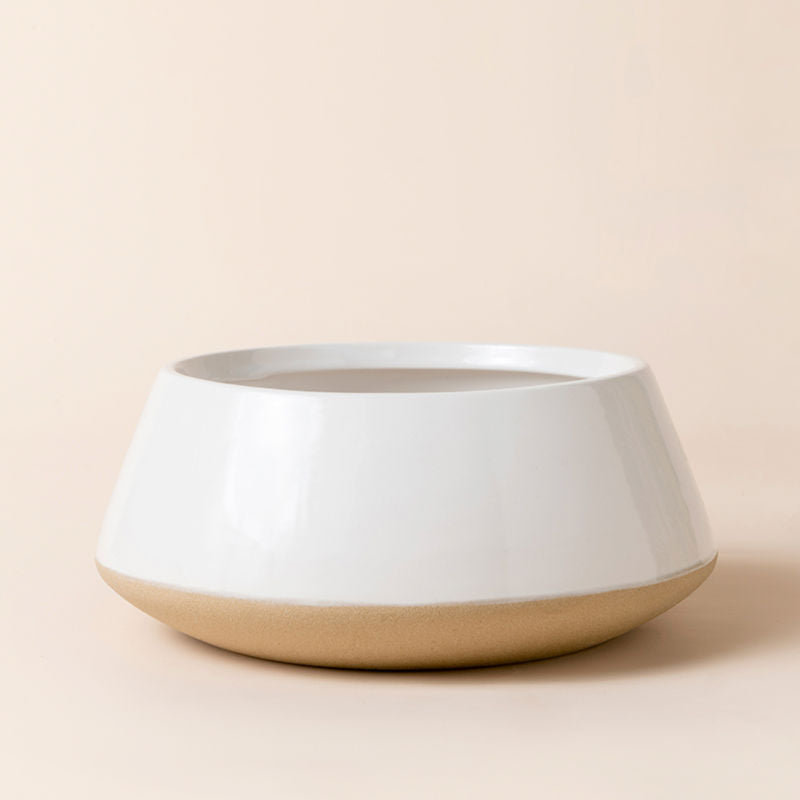 The oval-shaped planter in white and beige color, made of premium ceramic.