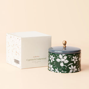 A jar of Cedarwood and Cypress Fragrance candle with its white packing box. 