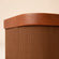 A close view of chocolate brown basket with lid, showing its eco-friendly body made of recycled cardboard and PVC.