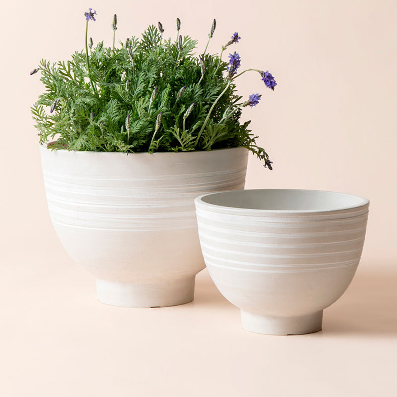 A set of two Cobie white planters in different sizes, made from recyclable plastic and natural stone powders.