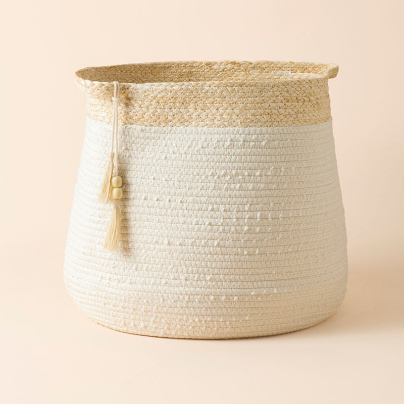 A whole scene of cotton and corn skin laundry basket, decorated with tassels and comfortable handles.