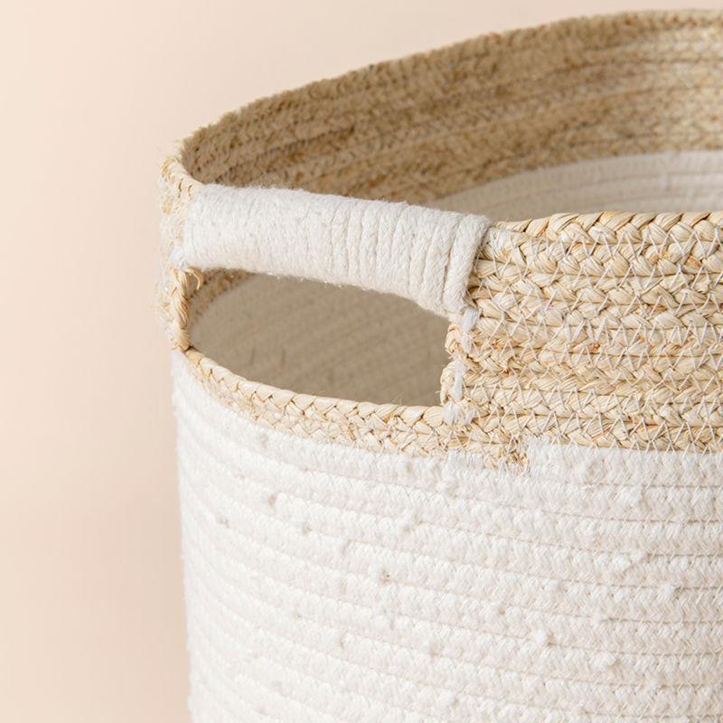 A close-up of the rounded rectangle basket, showing its corn skin woven and built-in handle.