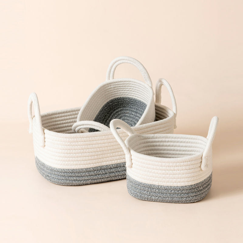 Two cotton rope baskets are stacked in behind, the small basket is at front.