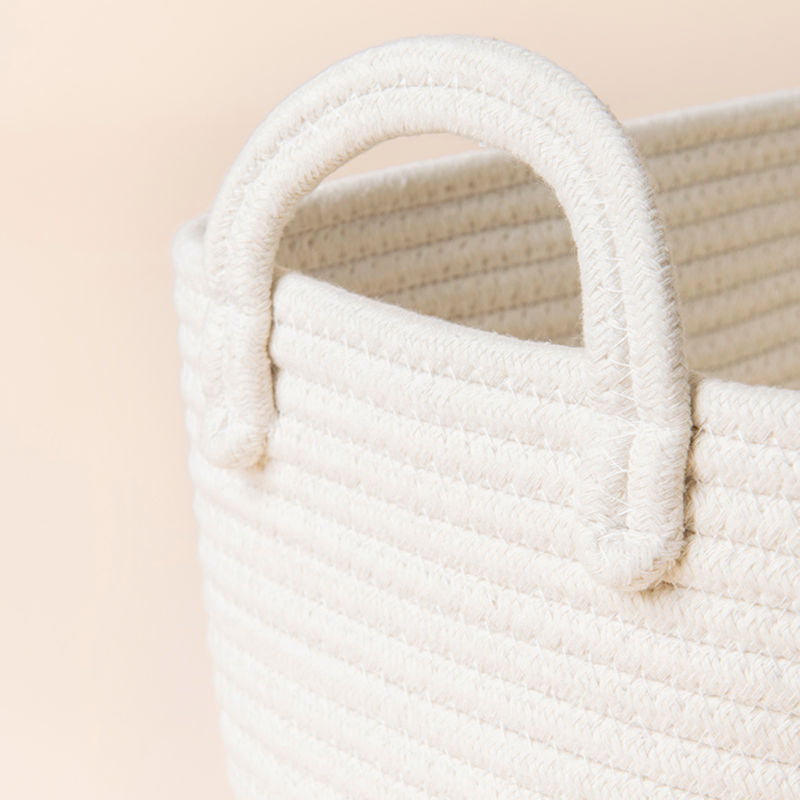 A close-up of cotton rope storage basket, showing its pure cotton and handle features.