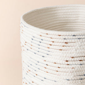 A close-up of cotton rope storage basket, the colored spots decorate your room into a convivial space.