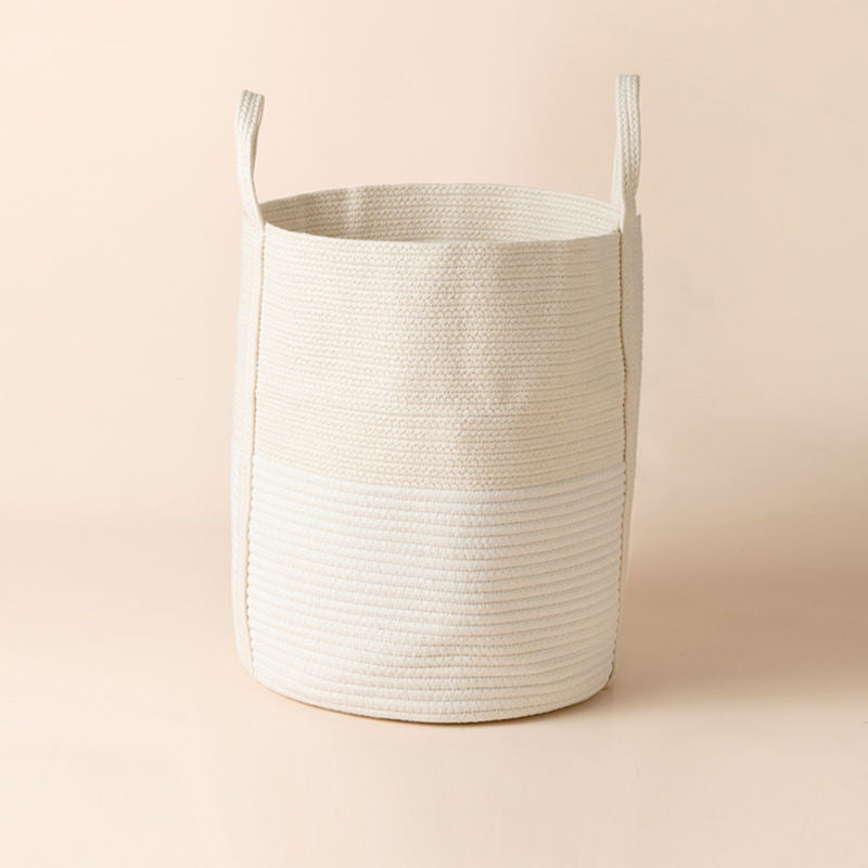 A full view of white and yellow cotton rope storage basket, showing it coiled woven and bucket form.