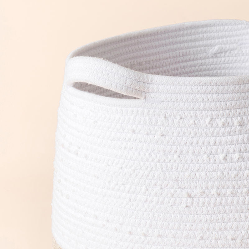 A close-up of the cotton rope laundry basket, showing its cotton handle and coiled cotton woven pattern.