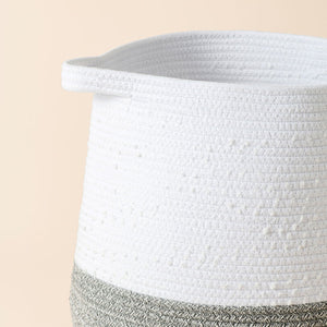 A close-up of the cotton rope laundry basket, showing its cotton handle and coiled cotton woven pattern.