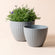 A set of two dawn gray planters with cube pattern, made from recyclable plastic and natural stone powders.