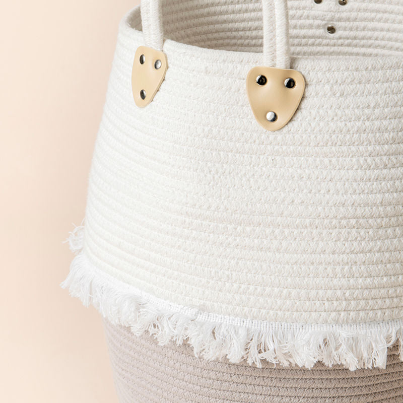 A side view of the cotton rope laundry basket, showing its white tassels which decorate your house with grace.