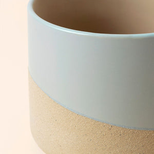 A close picture of the Duna gray & beige pots in size large, displays the mixture of sandy and ceramic glazed texture.