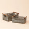 A pair of gray square baskets, handwoven with recycled paper ropes and wood handles.