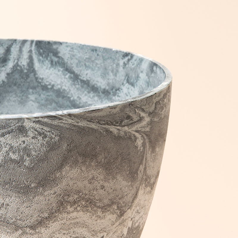 A close-up of the planter, showing its waves marble design around exterior and interior and lightweight feature.