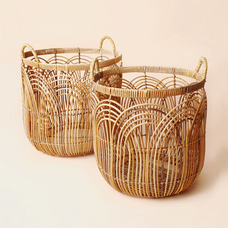 A set of two wicker laundry baskets with handles, handwoven with PE tubes and supported by a built-in iron frame.