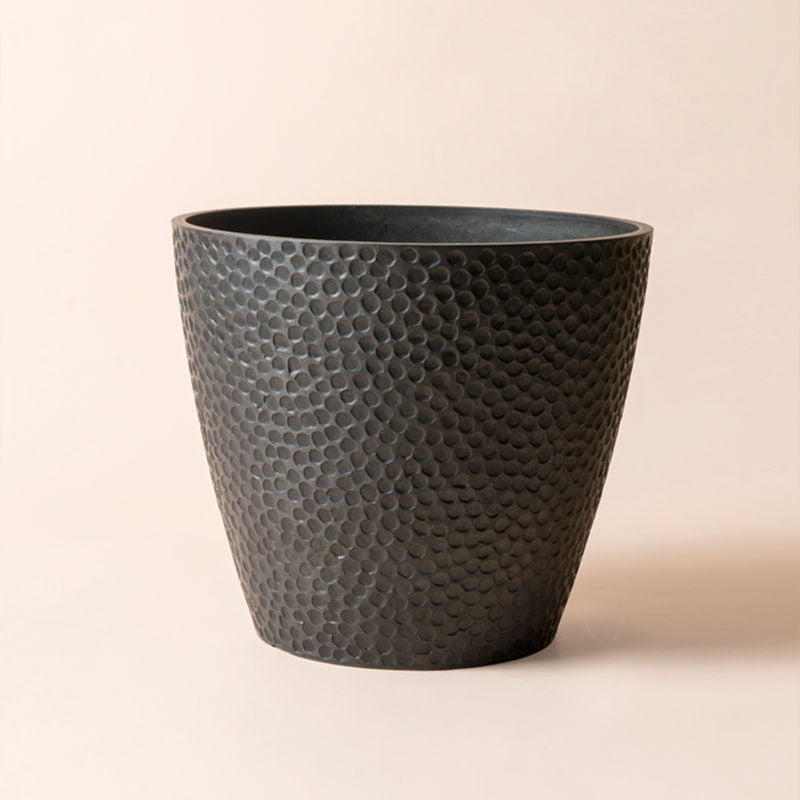 A full view of large black planter with honeycomb pattern, made from recyclable plastic and natural stone powders.