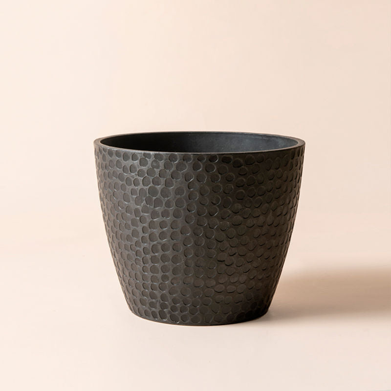 A full view of honeycomb pattern black pot, made of recyclable plastic and natural stone powders.