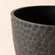 A close up of black planter, showing its unique honeycomb pattern and large dimension in 14 inches.